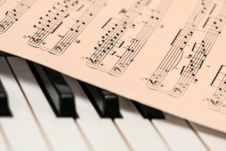 Song List Black and white piano keys with a sheet of classical music creating a harmonious composition.